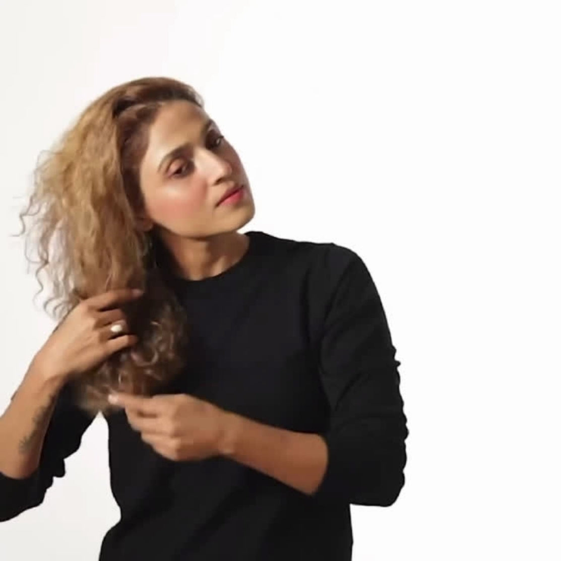 Model using hair perfume into her hair - Old product image by HOB India