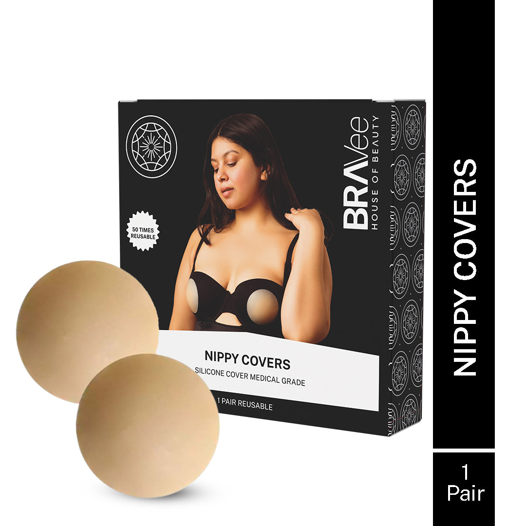 A product shot of a black box for "NIPPY COVERS SILICONE COVER MEDICAL GRADE," by BRAVEE HOUSE OF BEAUTY, showing the covers are "50 TIMES REUSABLE." The box features a model wearing the covers under a bra. A pair of beige nipple covers is displayed next to the box.