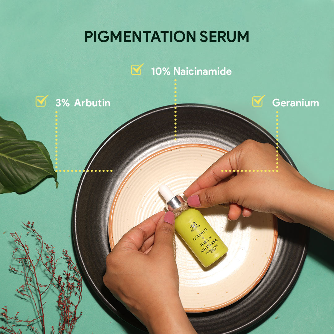 A yellow serum bottle held by four fingers on a green background over a round cream coloured plate with the heading PIGMENTATION SERUM and ingredients ARBUTIN, NAICINAMIDE AND GERANIUM.