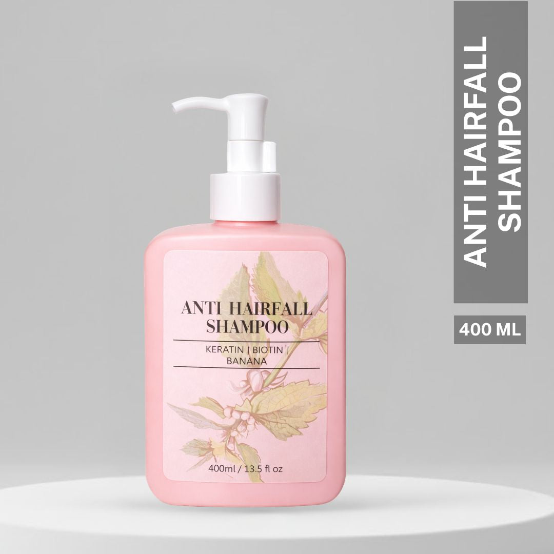 Pink House of Beauty Anti Hairfall Shampoo 400ml bottle with pump dispenser featuring keratin, biotin, and banana extract on a minimal grey background.