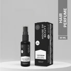 A sleek black bottle of House of Beauty Hair Perfume with packaging, featuring Amla, Vitamin E, and Arabian Rose Oud Oil. The bottle and box are displayed side by side on a minimalist, neutral background.